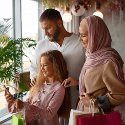 Family smiling and looking at a phone
