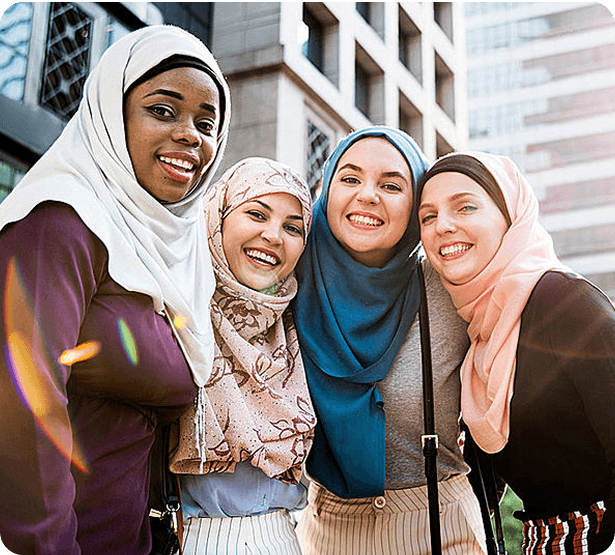 Four muslim women in hijab smiling for the photo